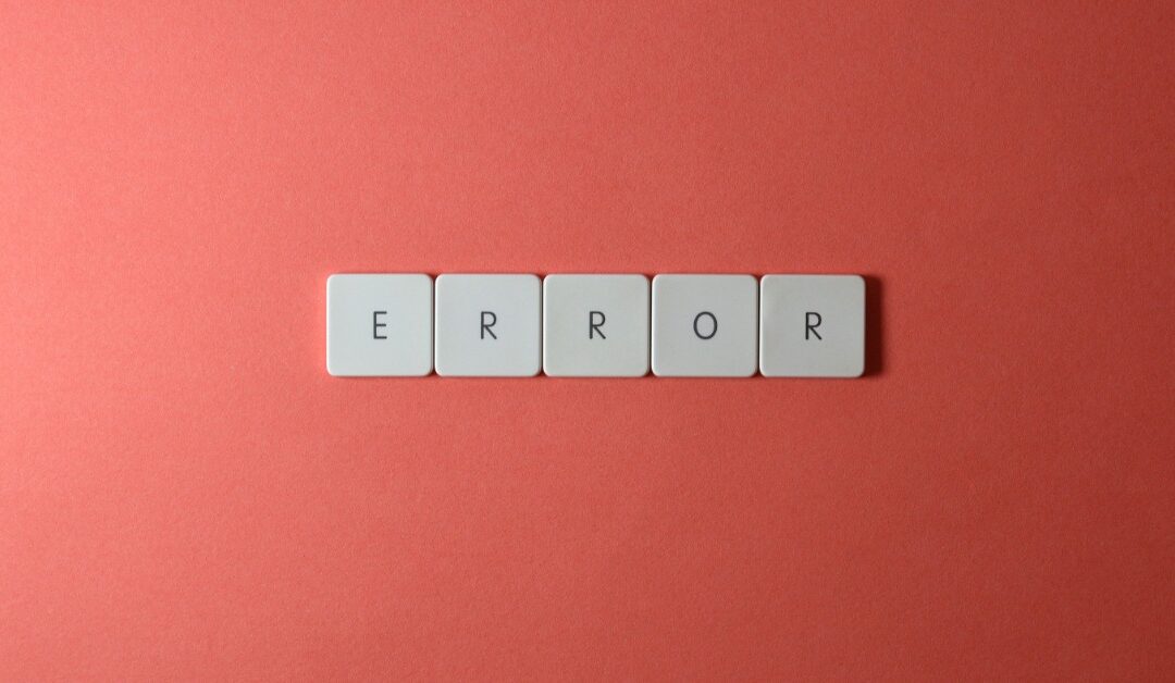 White tiles with individual letters on them spell out "ERROR" on a red table.
