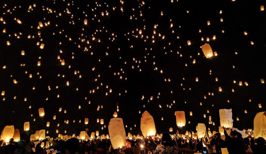 Countless floating candles light up the sky, much like the effects of collective effervescence.